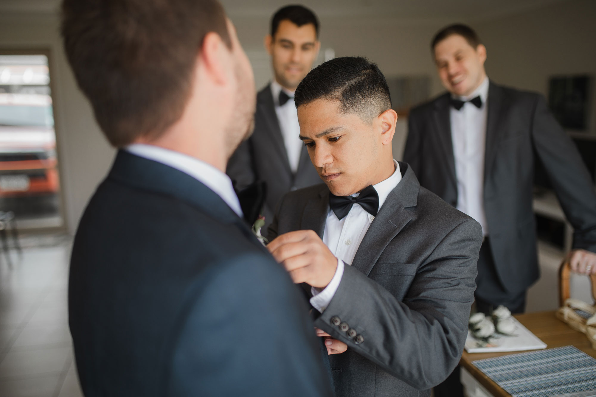 groom putting on tie