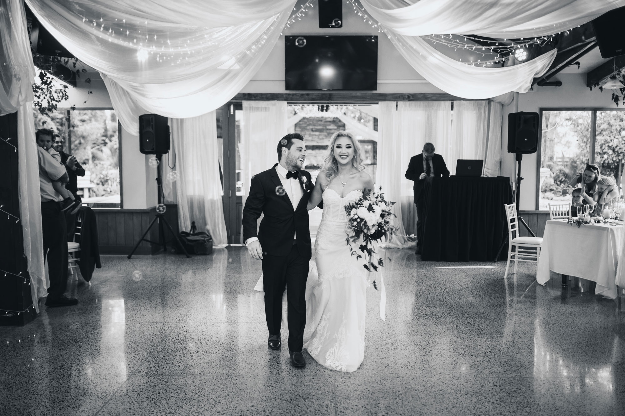 bride and groom arriving at wedding reception