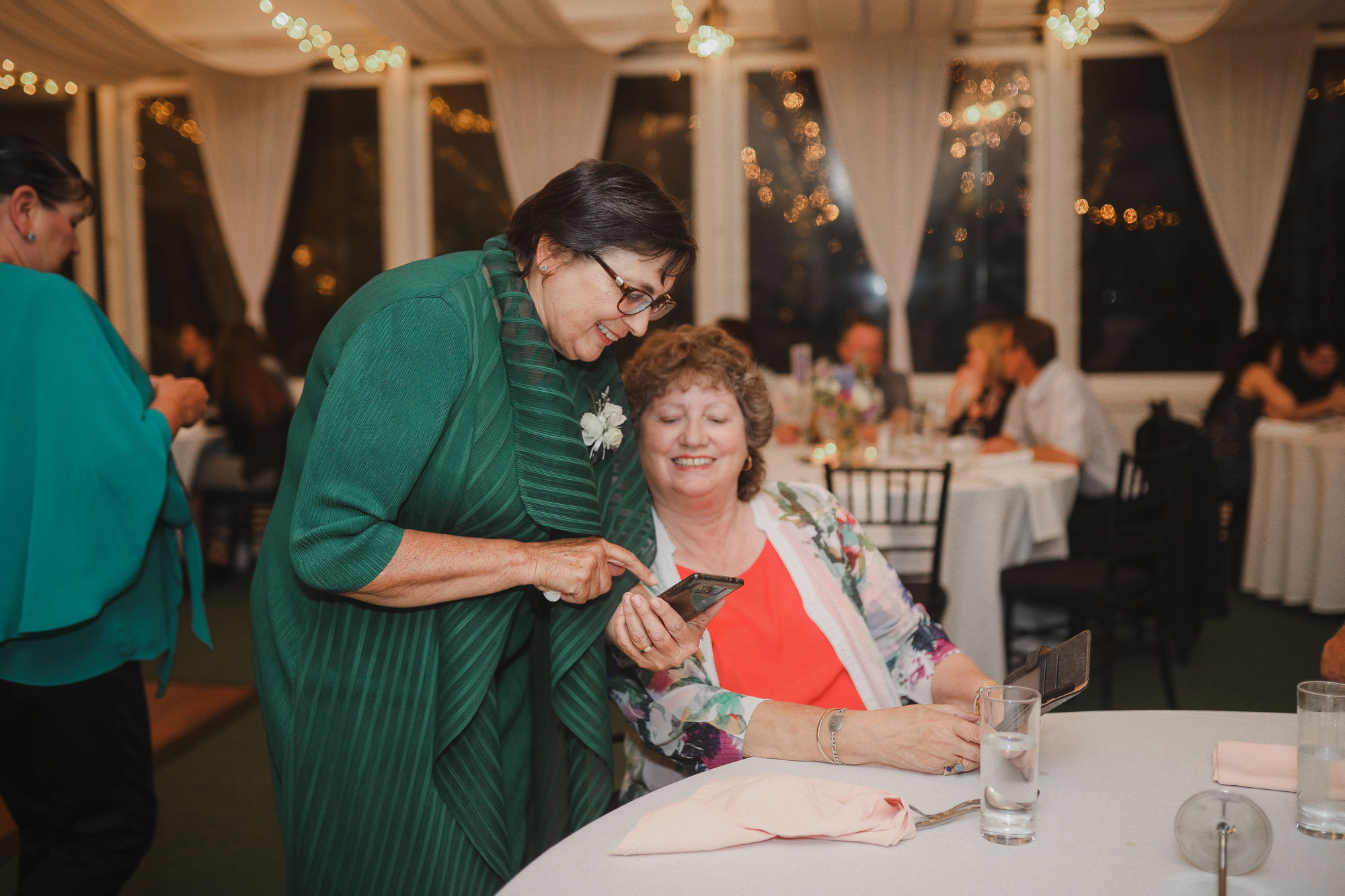 wedding guests looking at phone