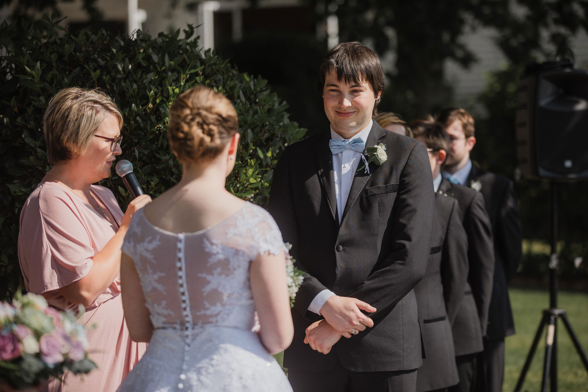 groom smiling at bride