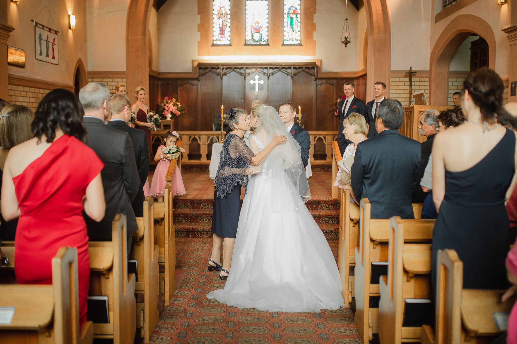 bride and mother kiss