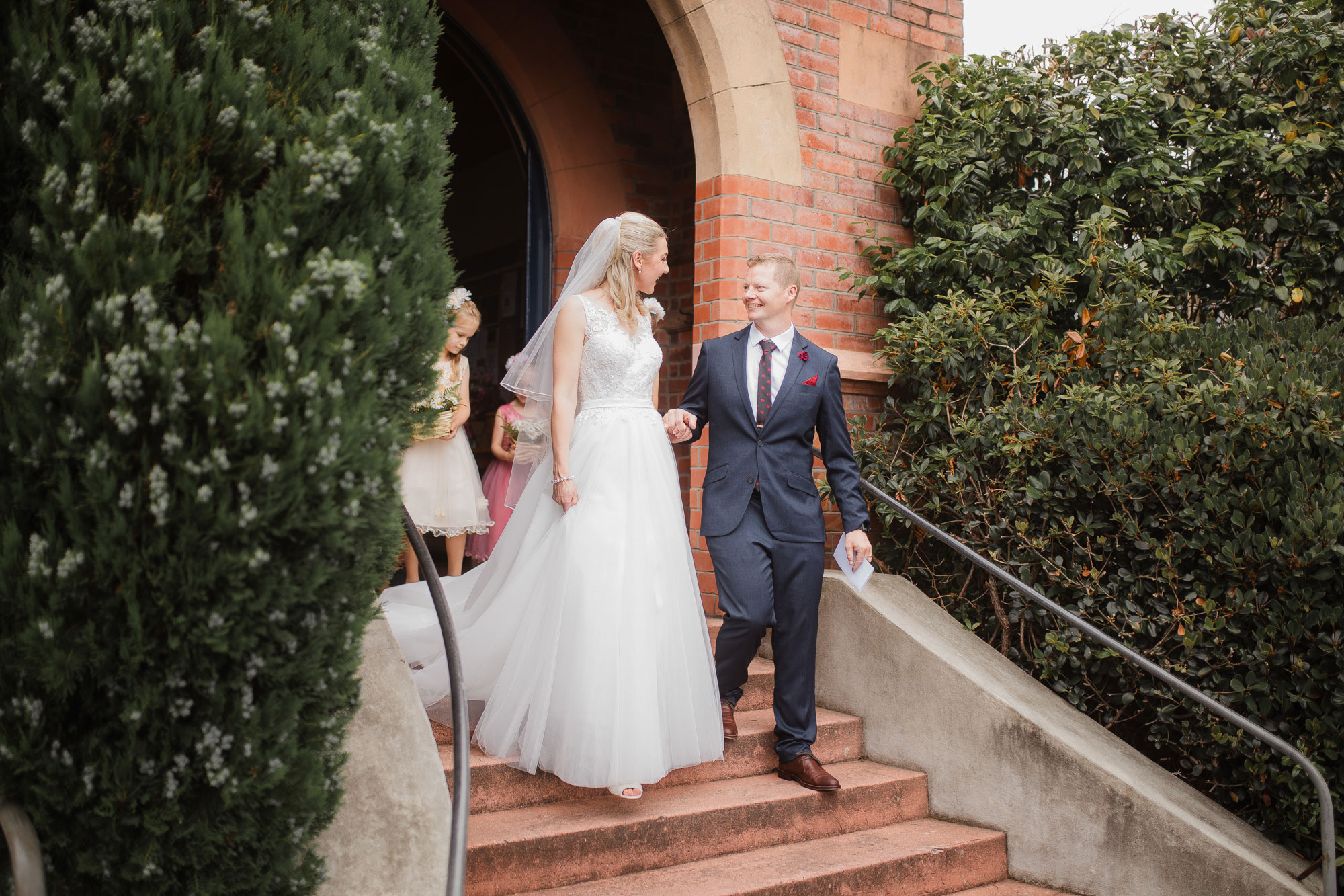 groom holding bride's hands