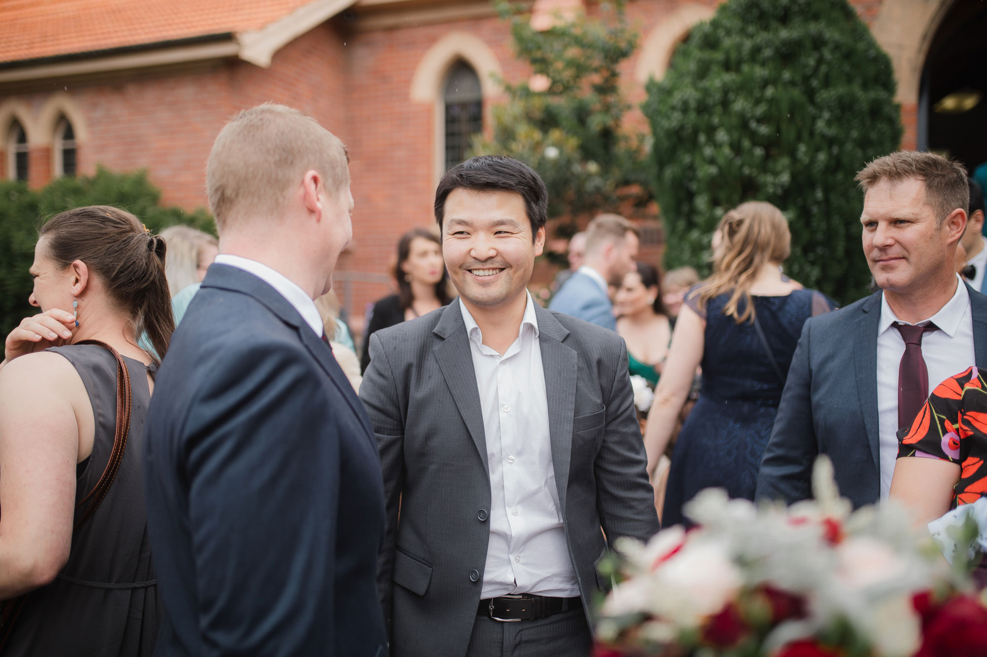 guests chatting with groom