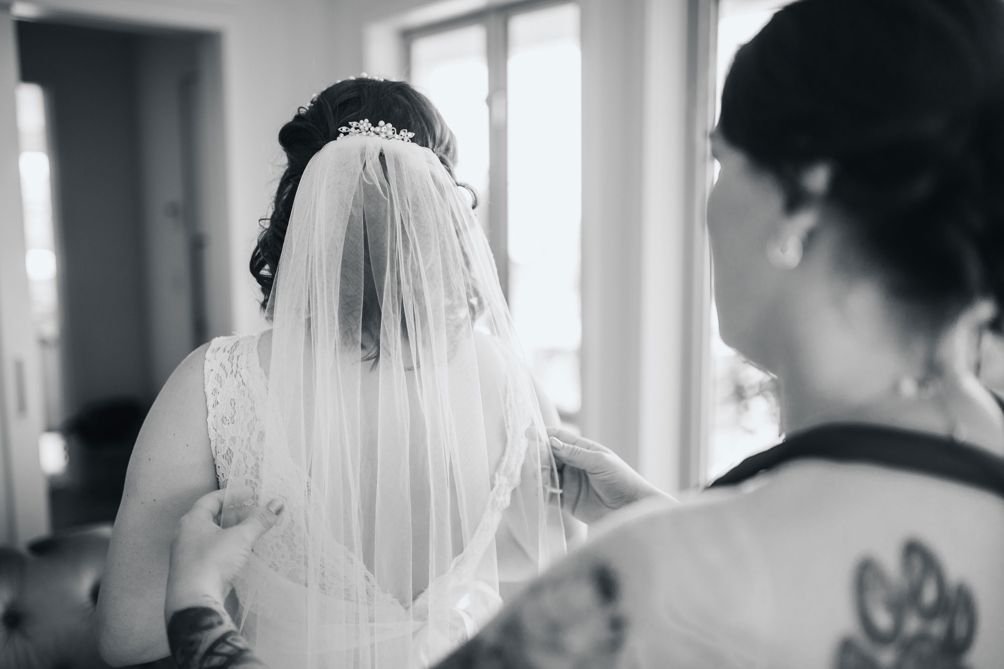 bride putting on veil