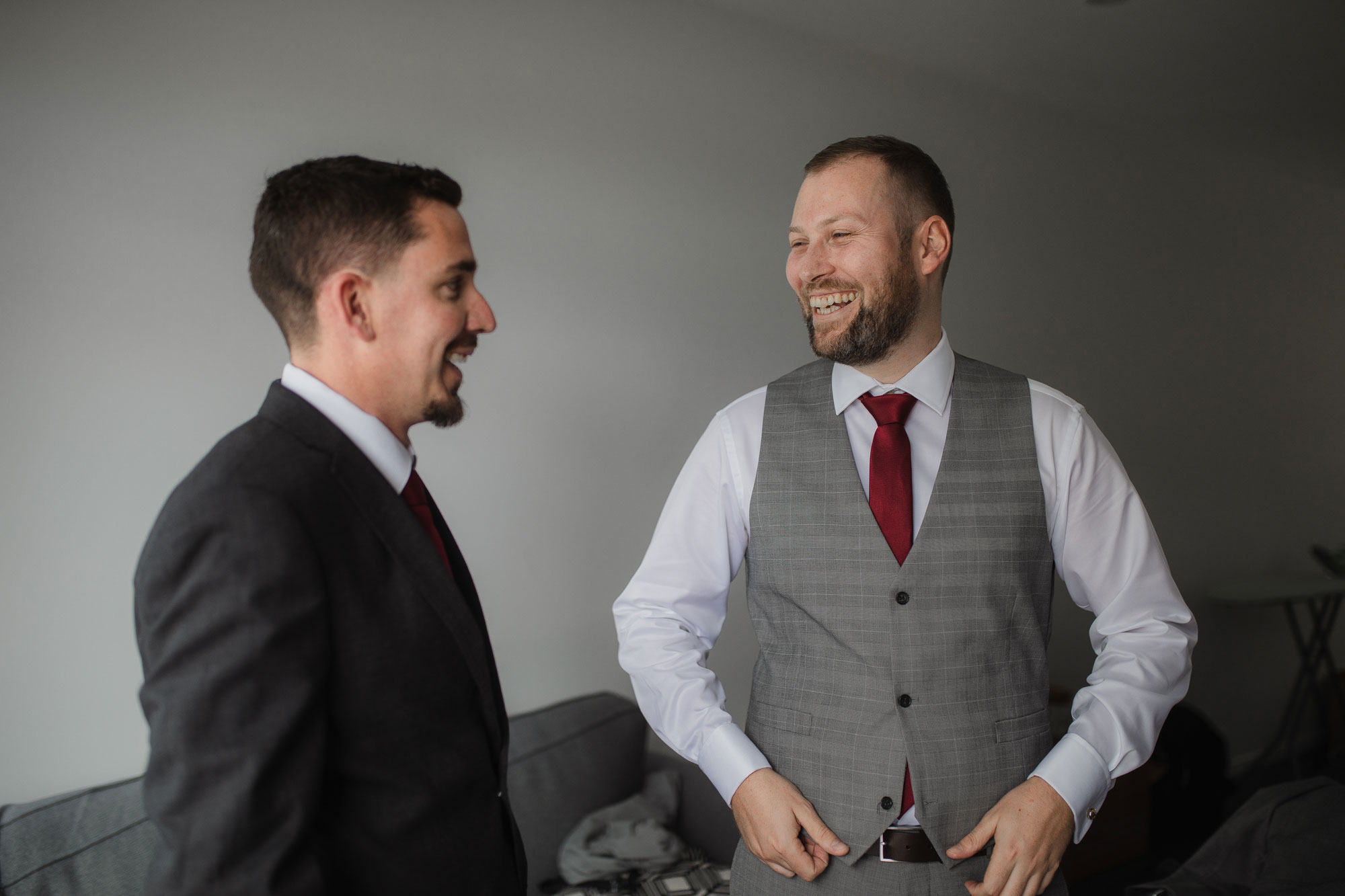 groom and groomsman smiling