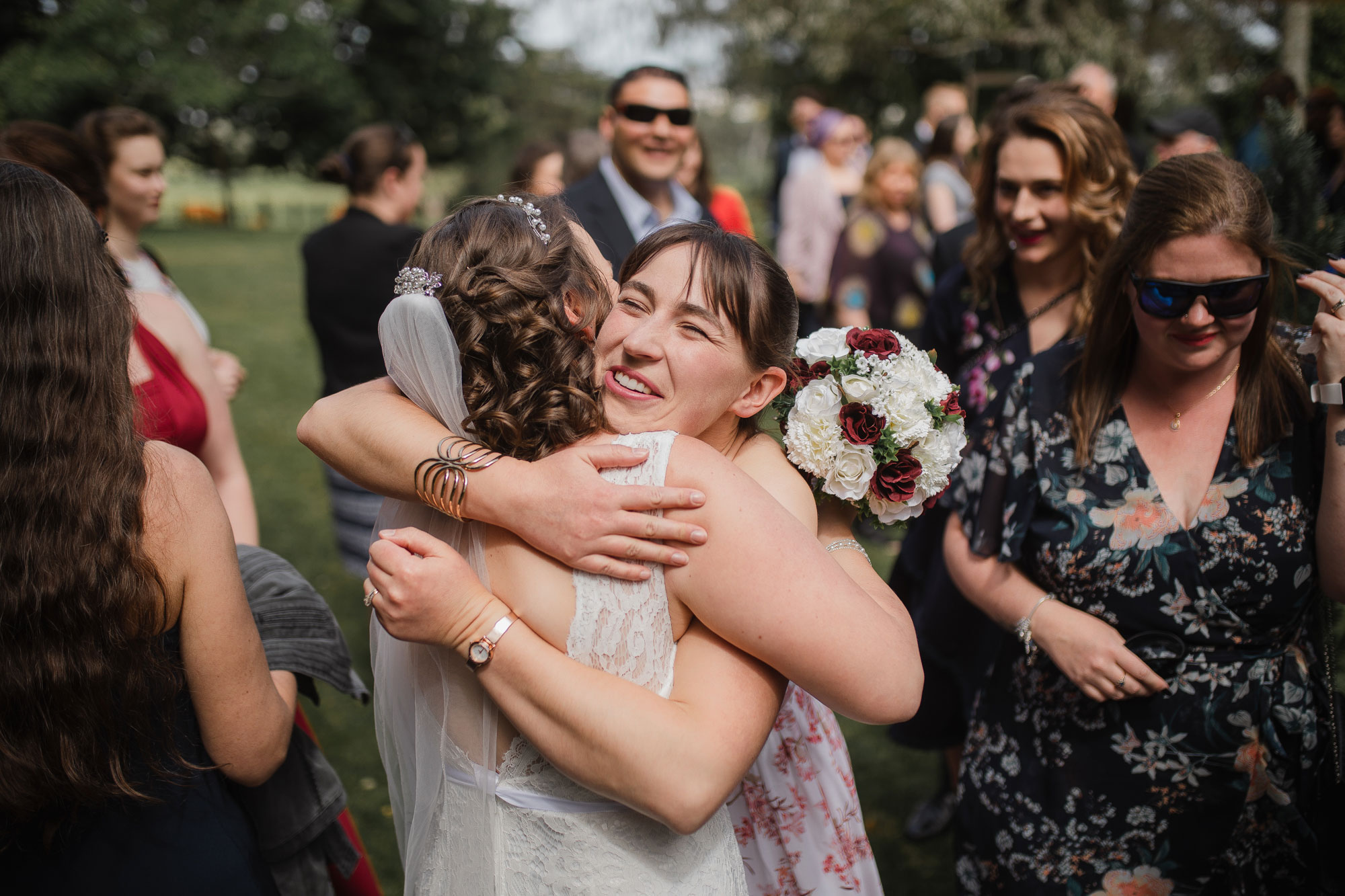 wedding guest hugging the bride