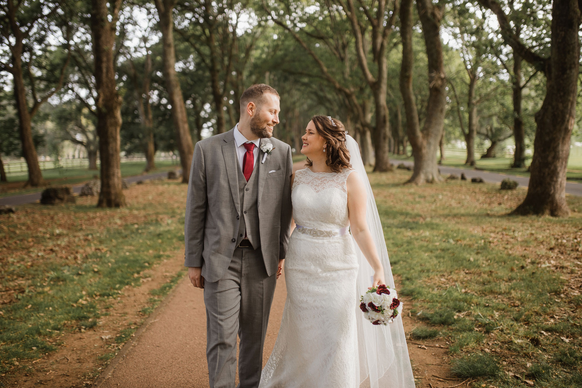 bride and groom walking cornwall park