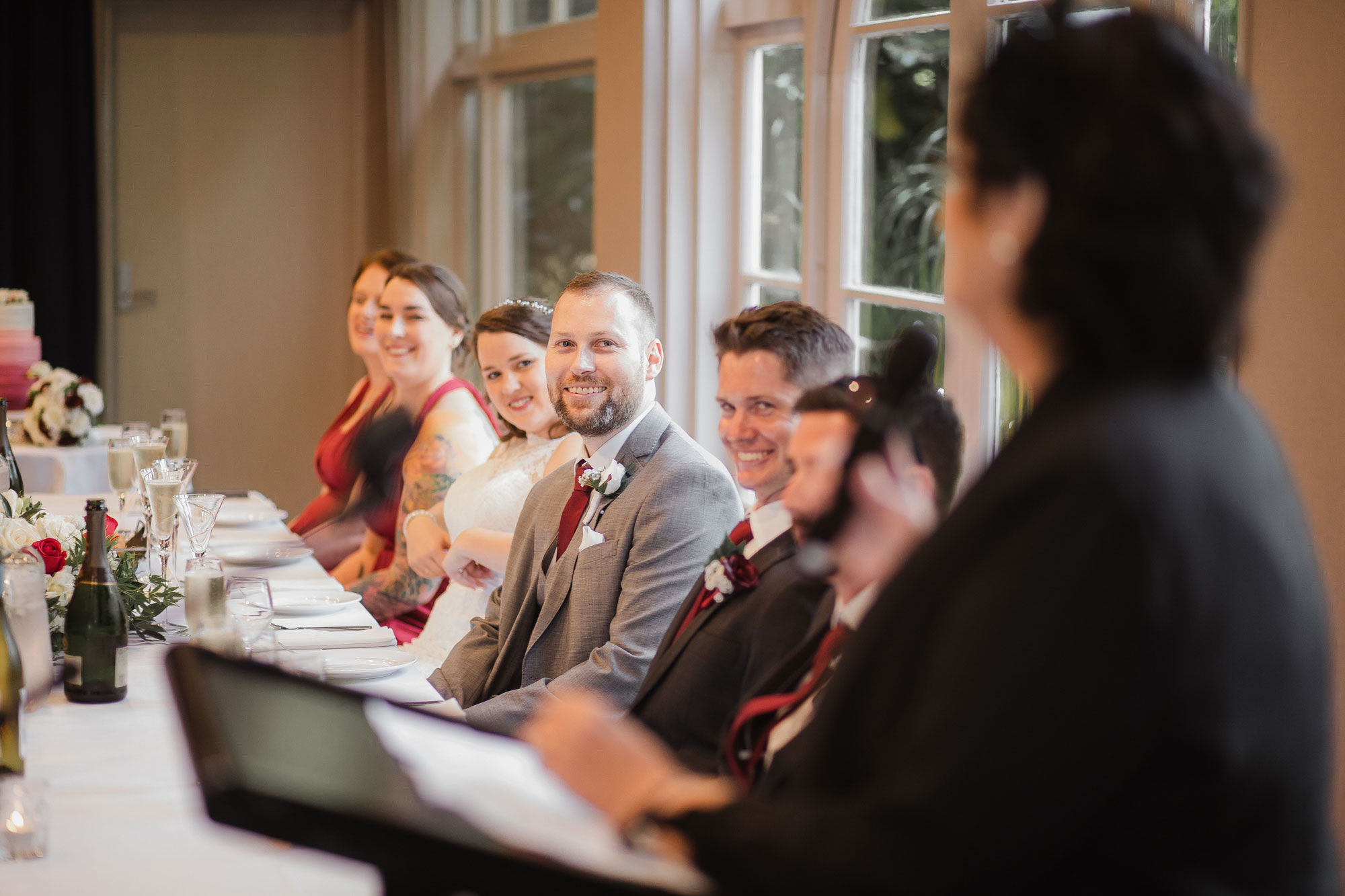 bride and groom listening to parent speech