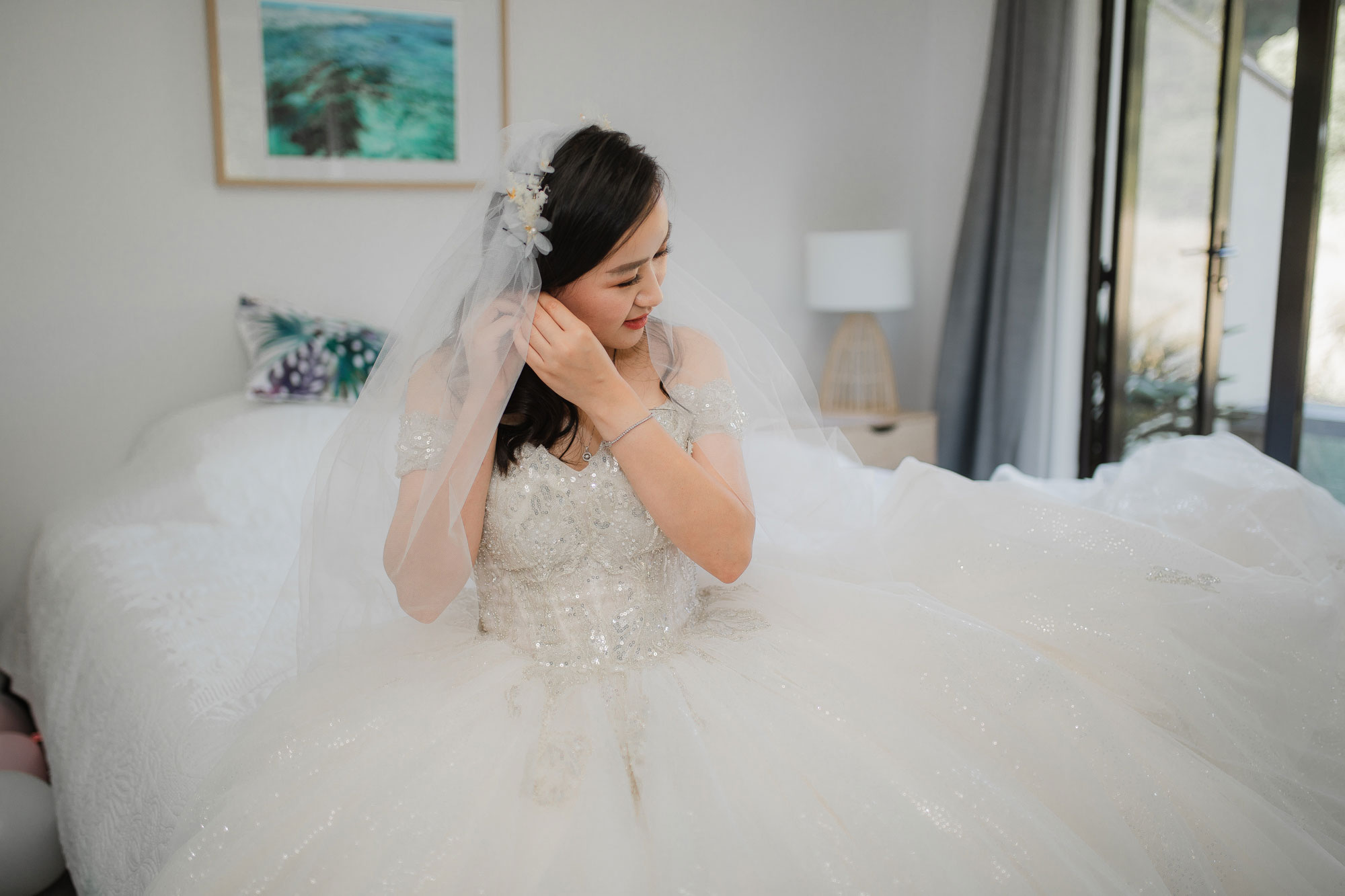 bride putting on earrings