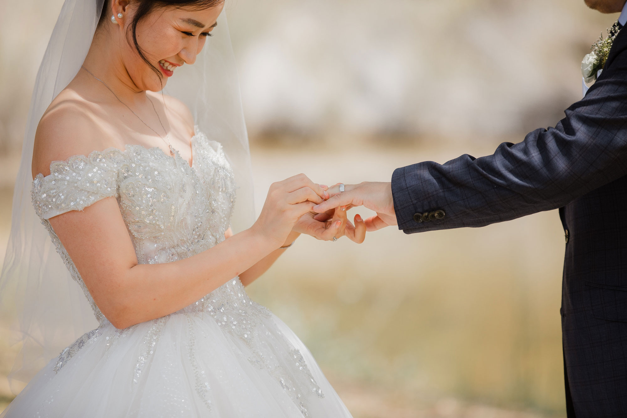 bride putting on ring