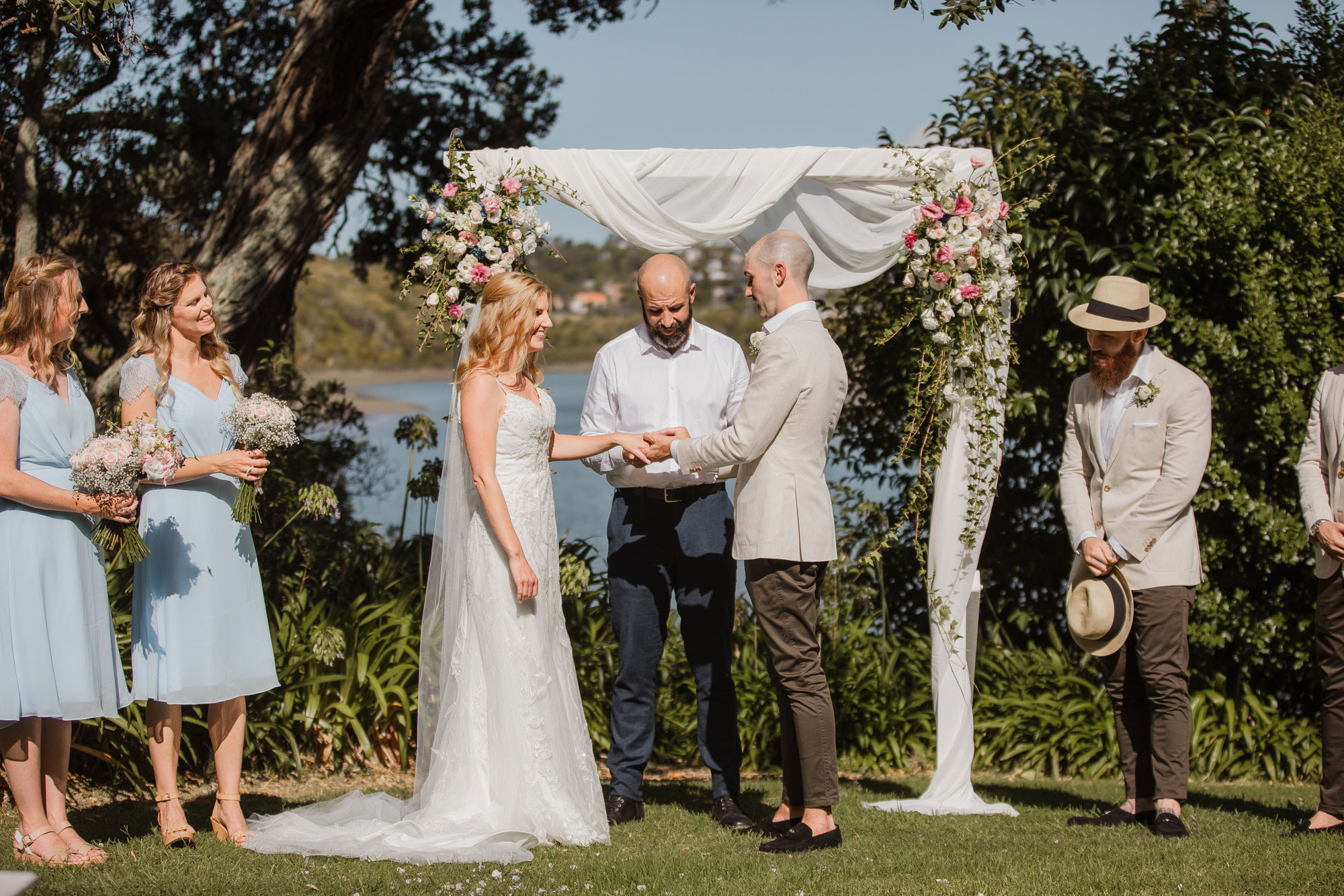 groom putting on wedding ring