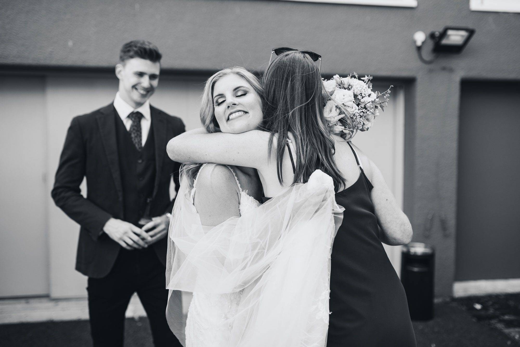 bride hugging wedding guests