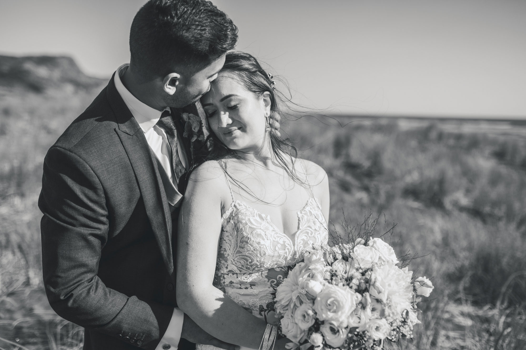 bride and groom at bethells beach