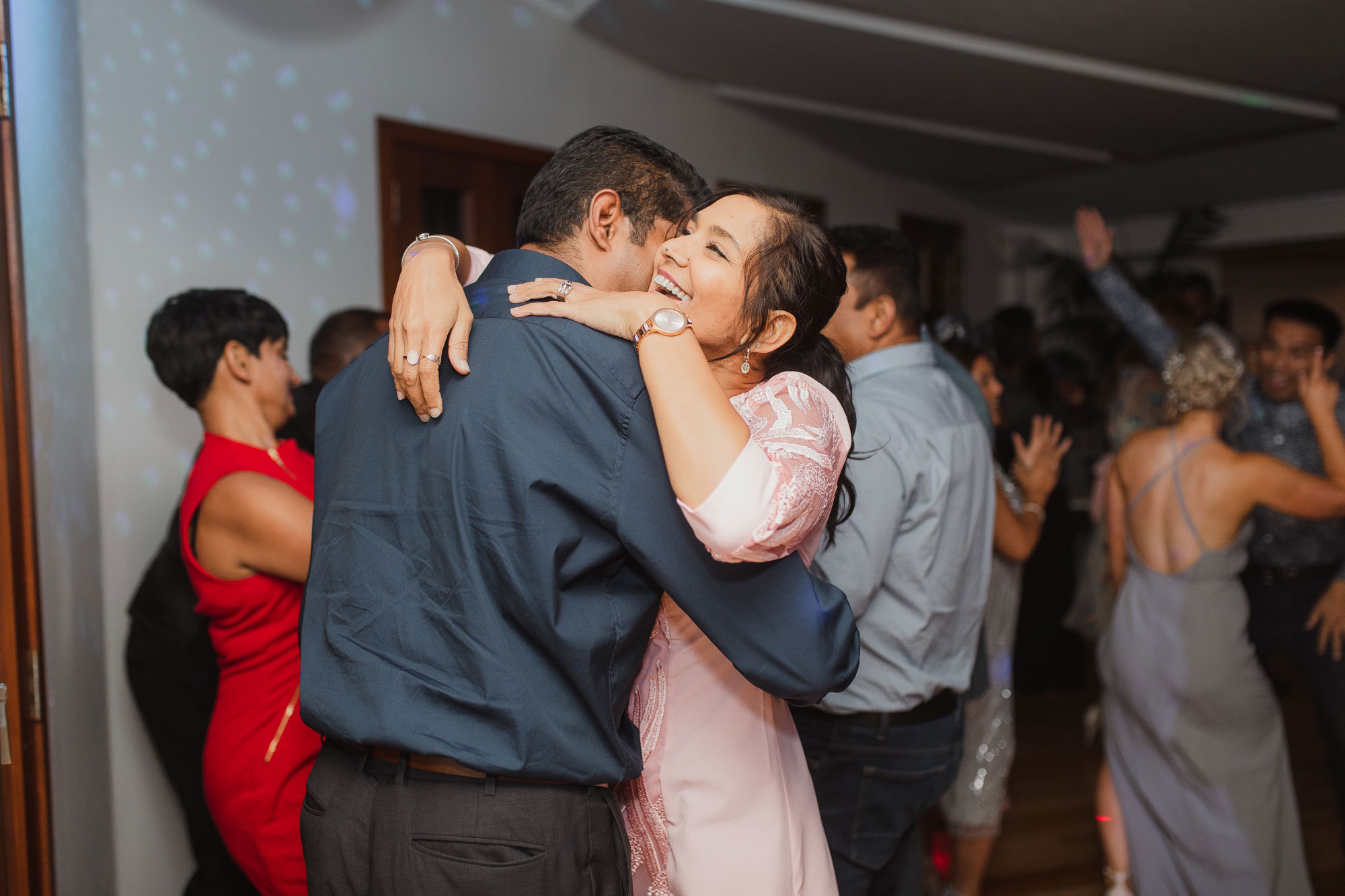 wedding guests hugging