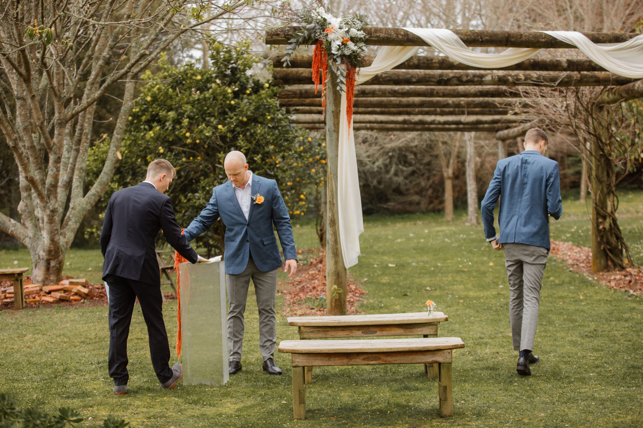 groomsmen setting up wedding ceremony