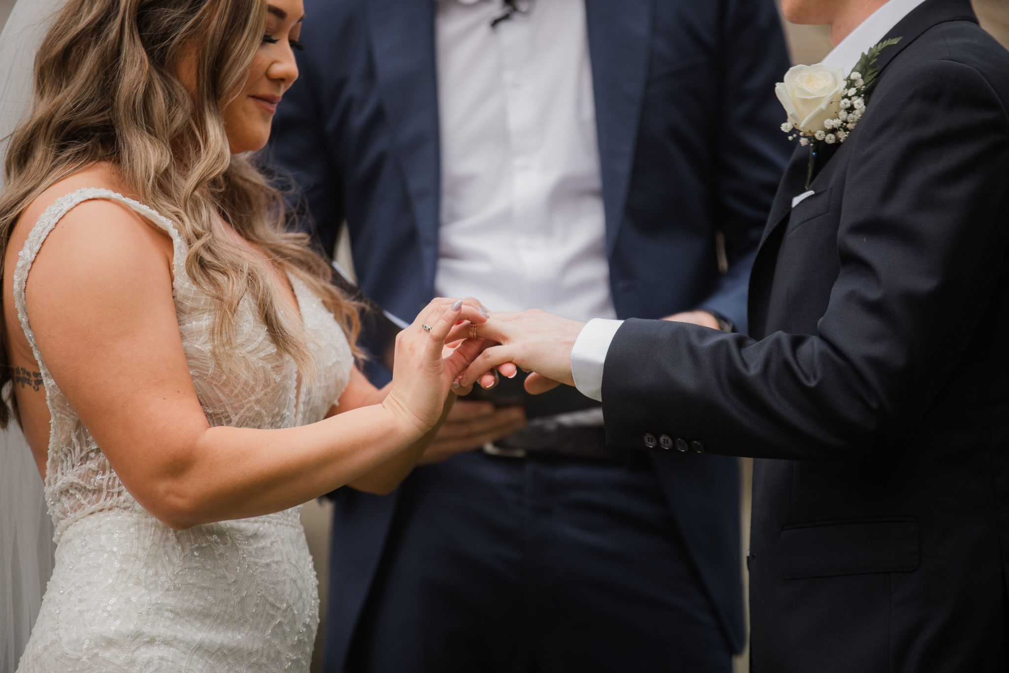 bride putting on wedding ring