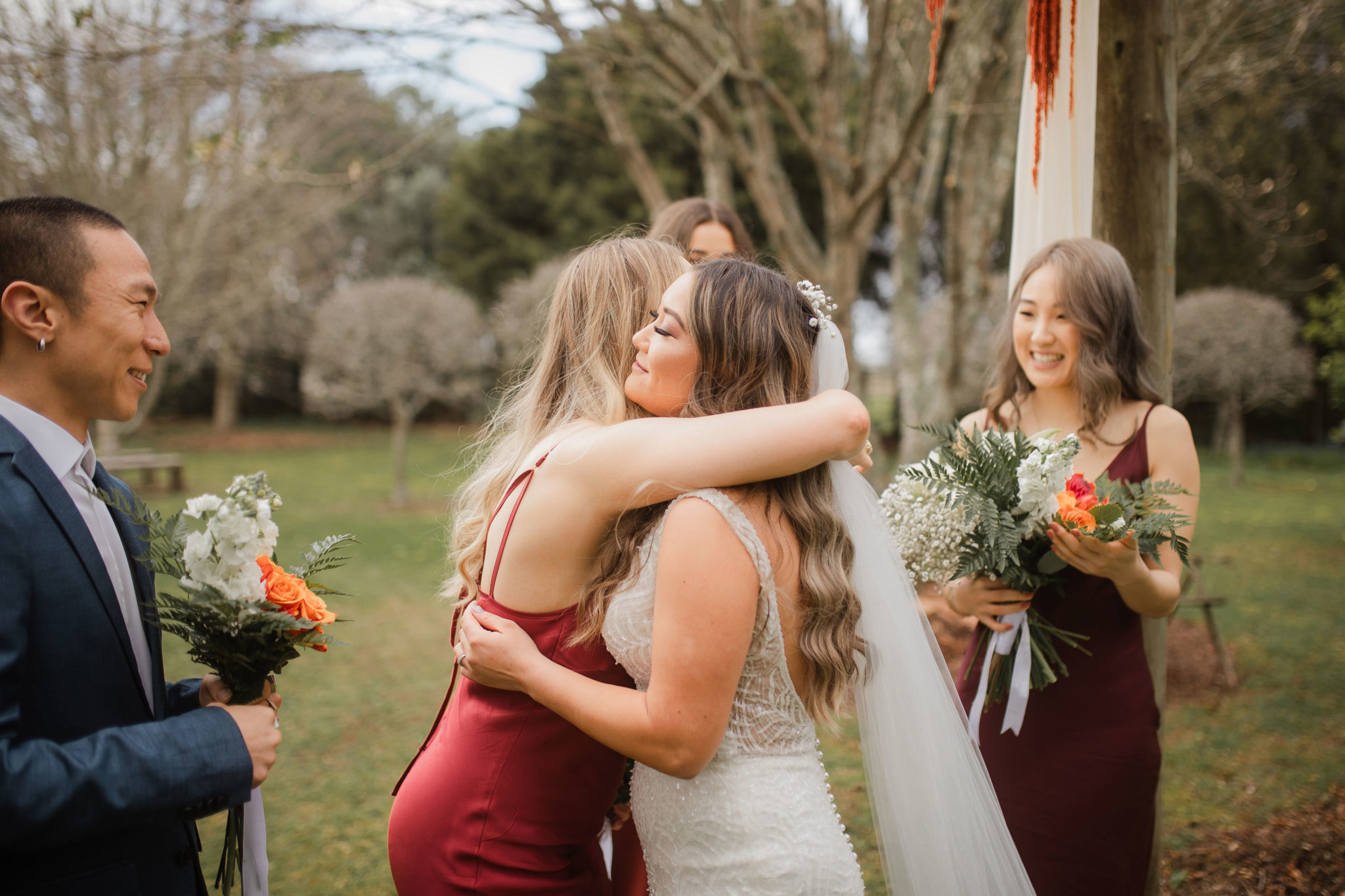 bride and bridesmaids hugging