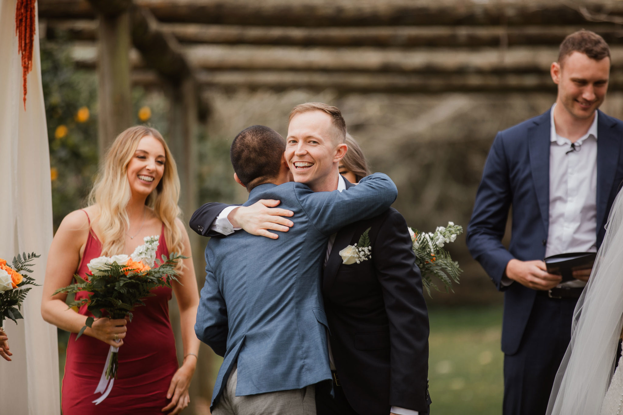 groom hugging wedding guest