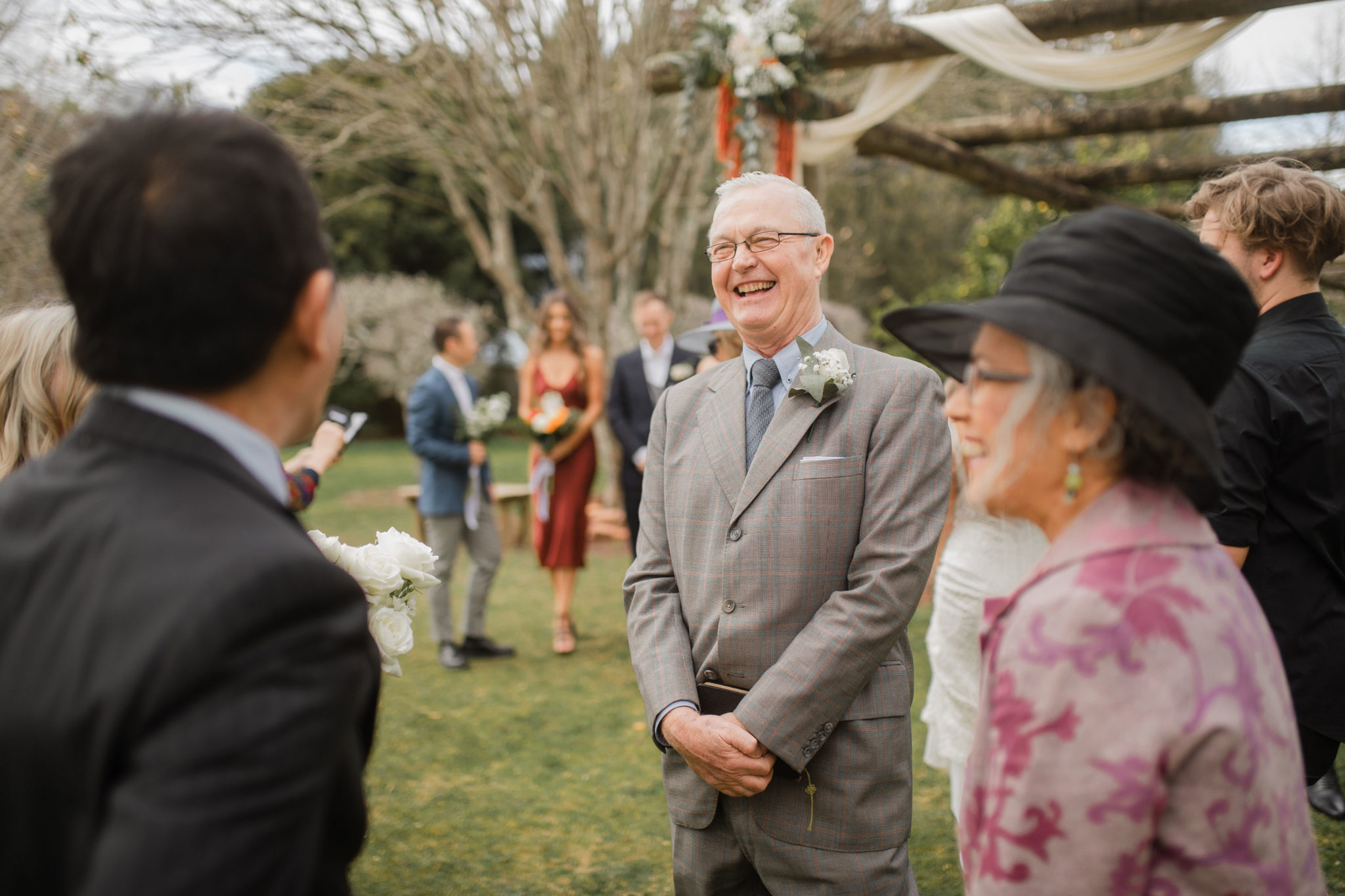 father of the groom laughing