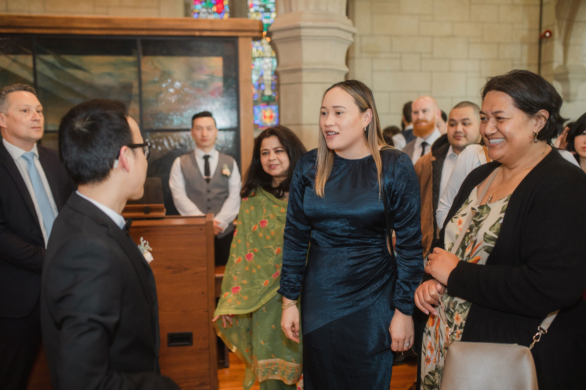 guests chatting with the groom