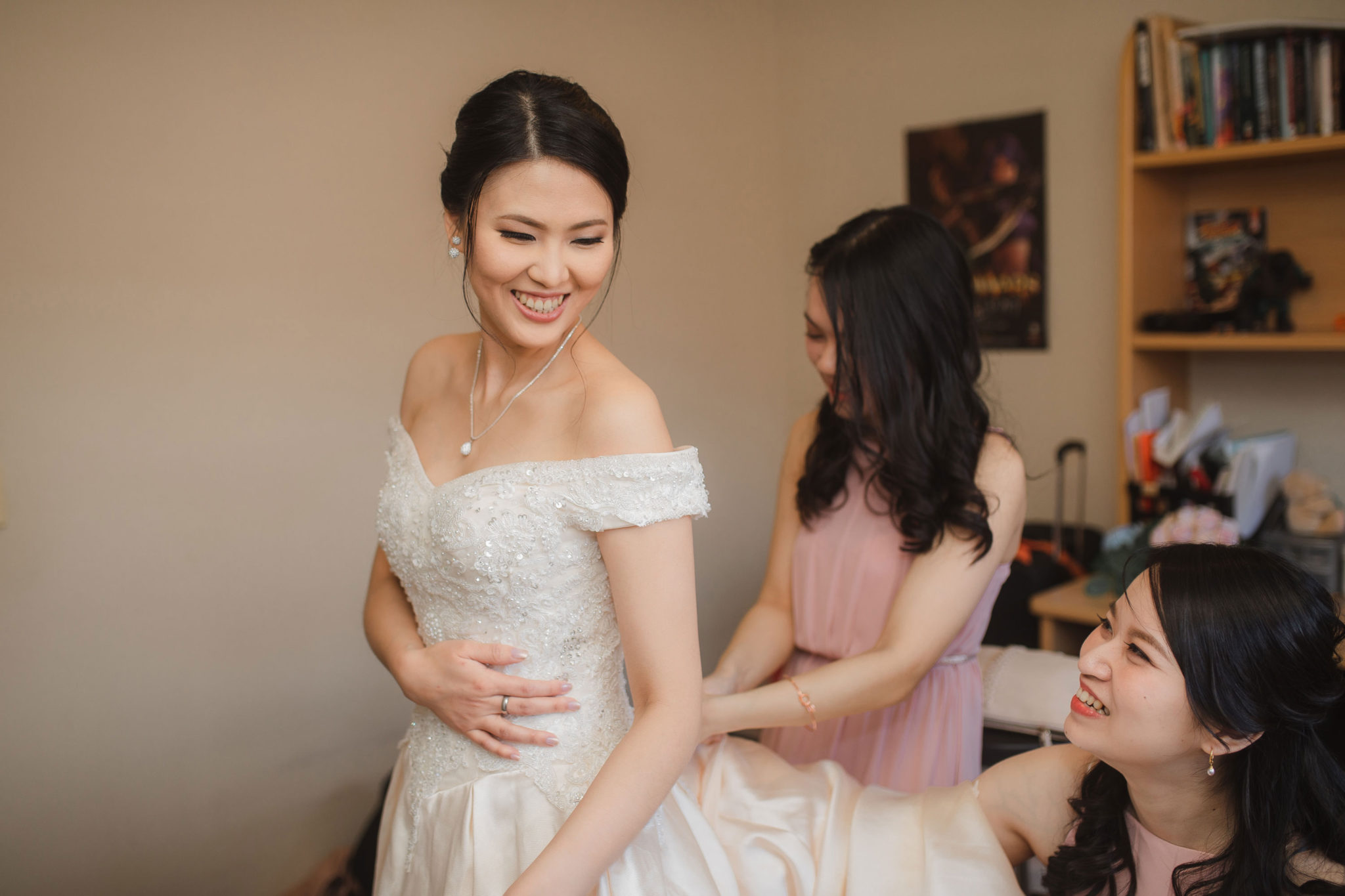 bride getting into wedding dress