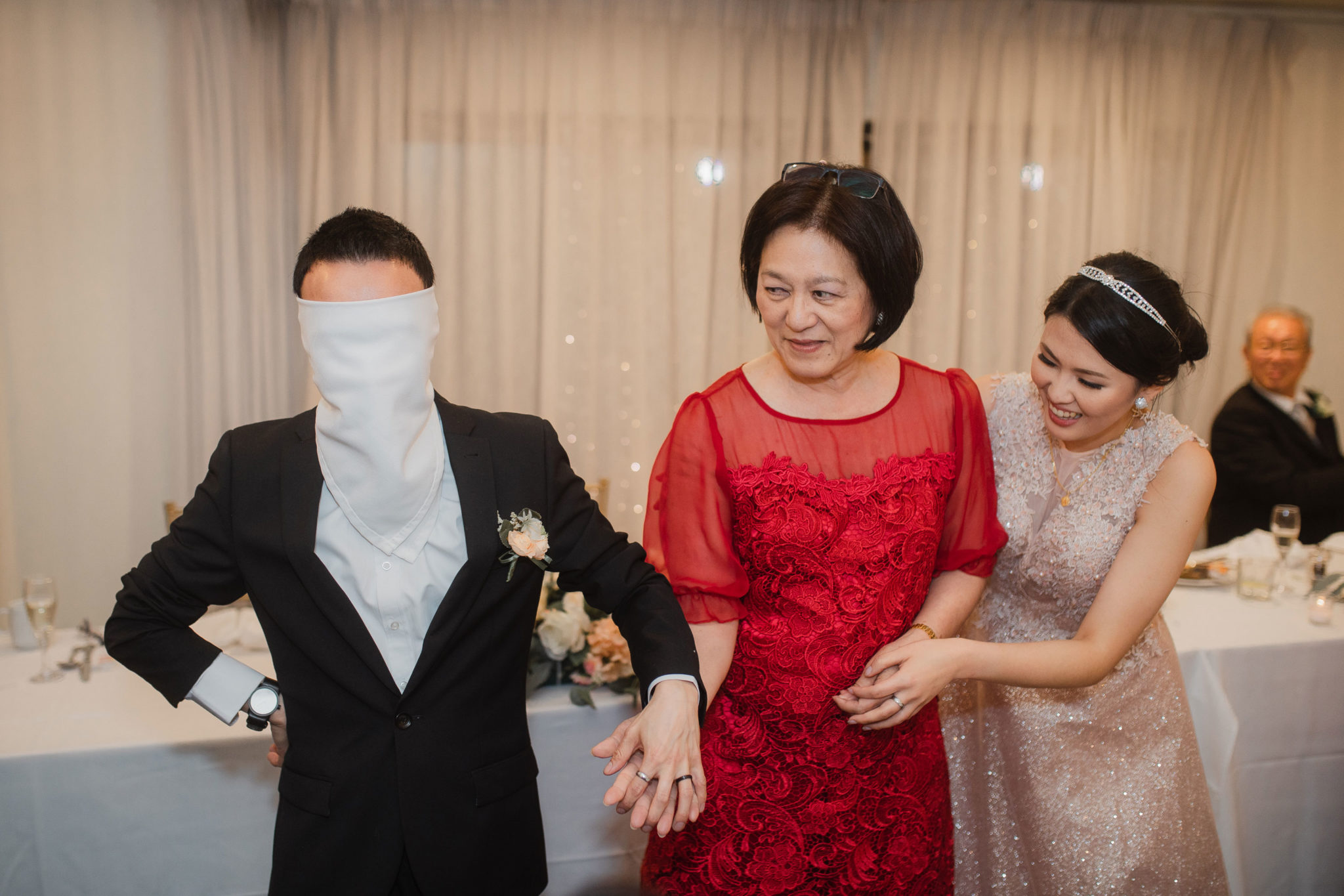 groom playing wedding hand game