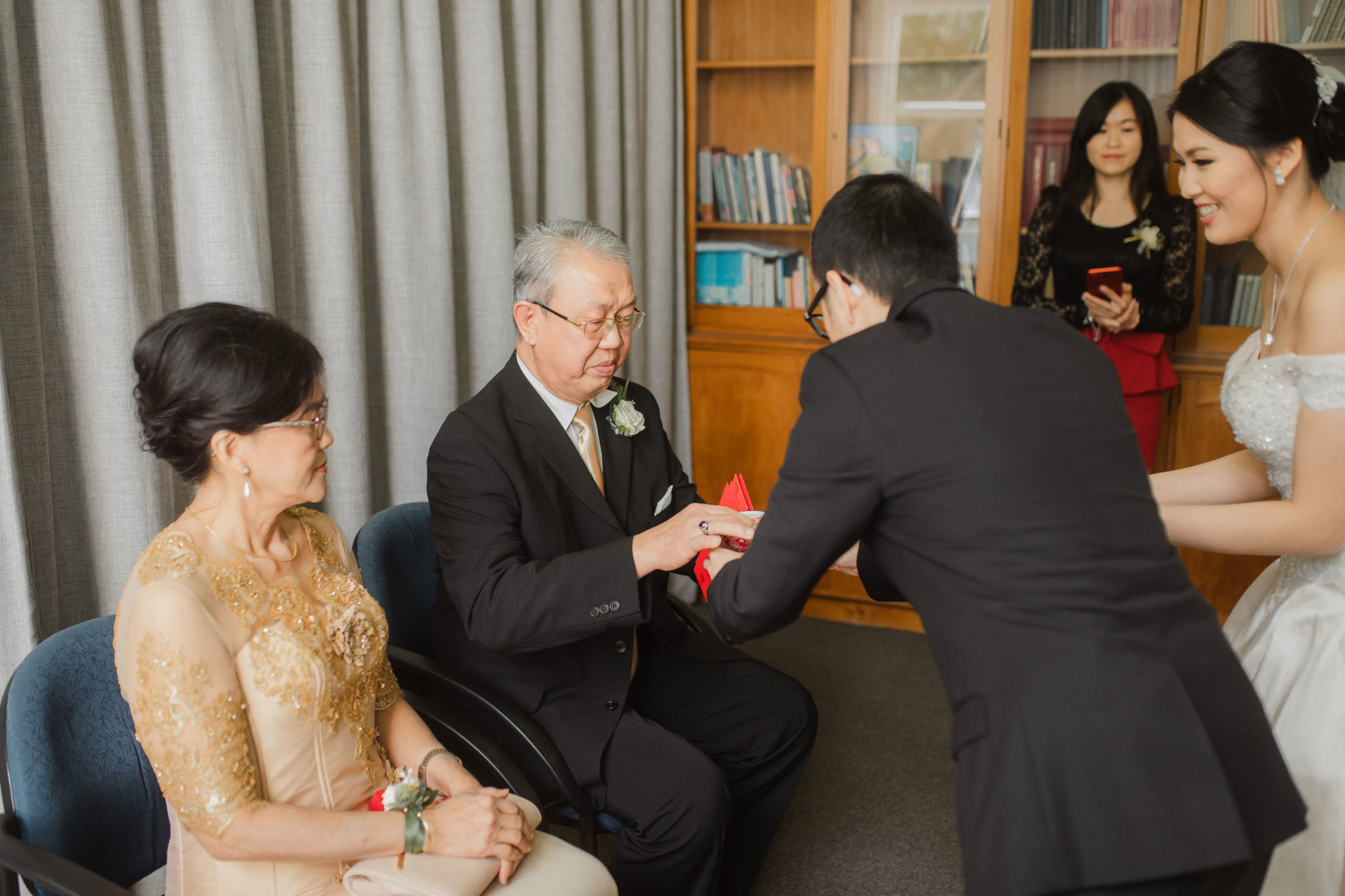 groom serving tea during ceremony