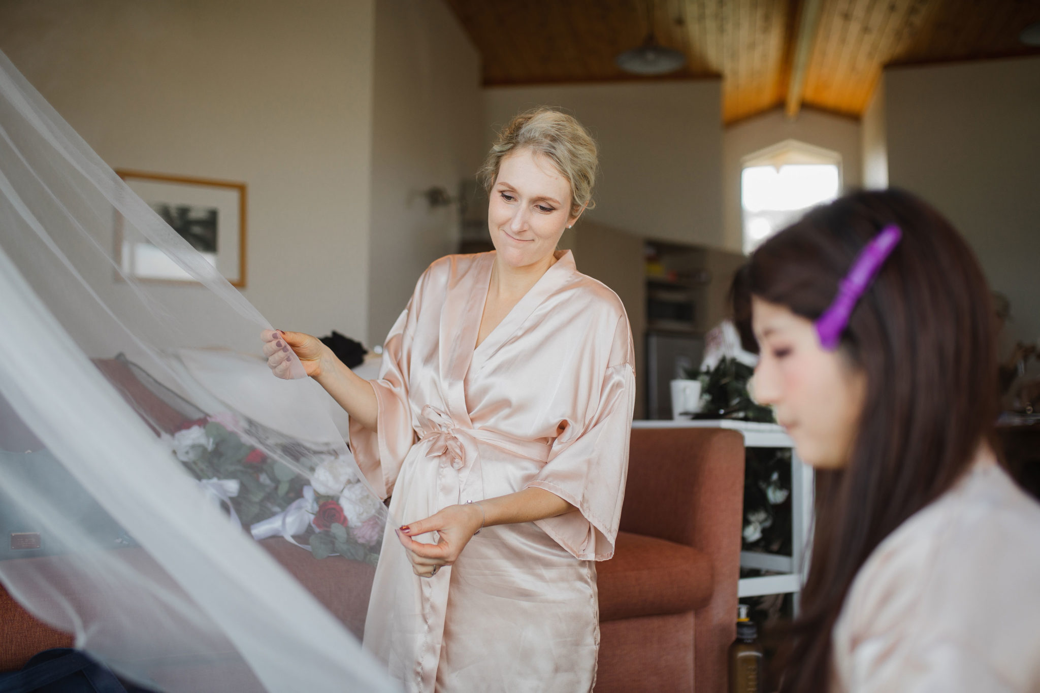 bridesmaids helping with bridal dress