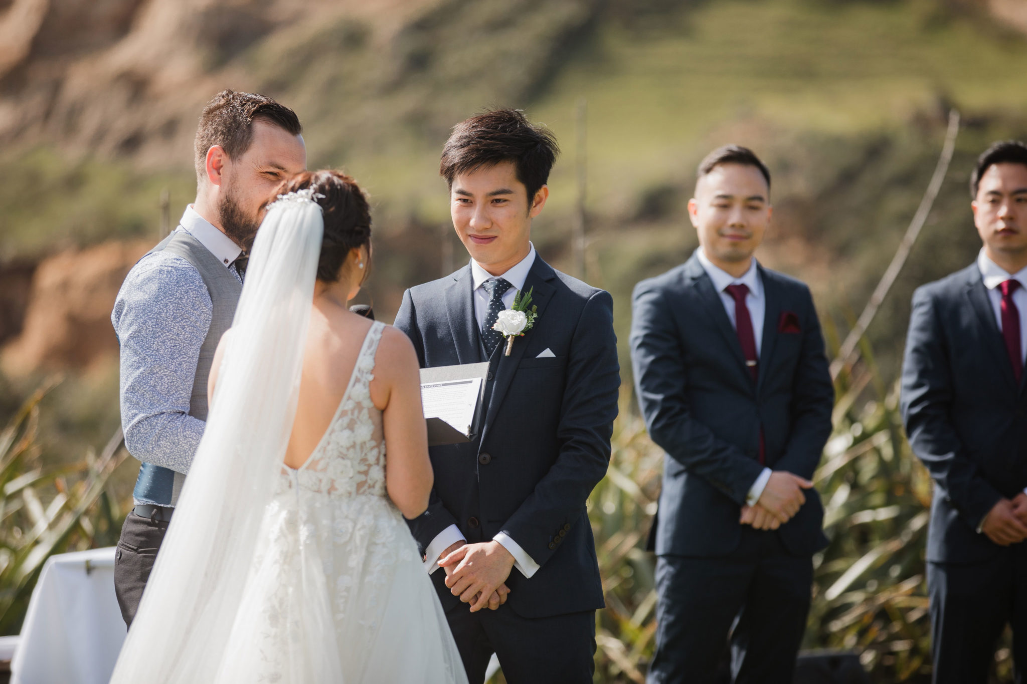 groom smiling at the bride