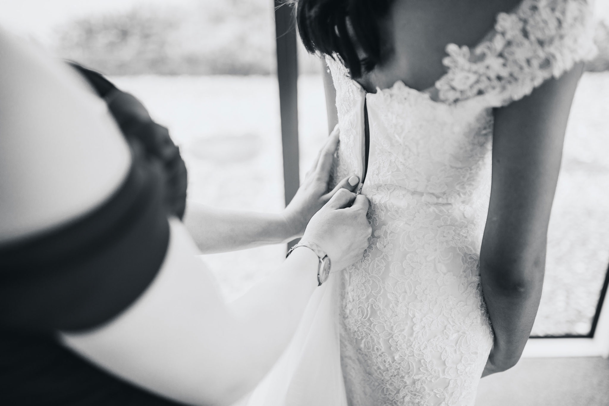 auckland bride getting into dress