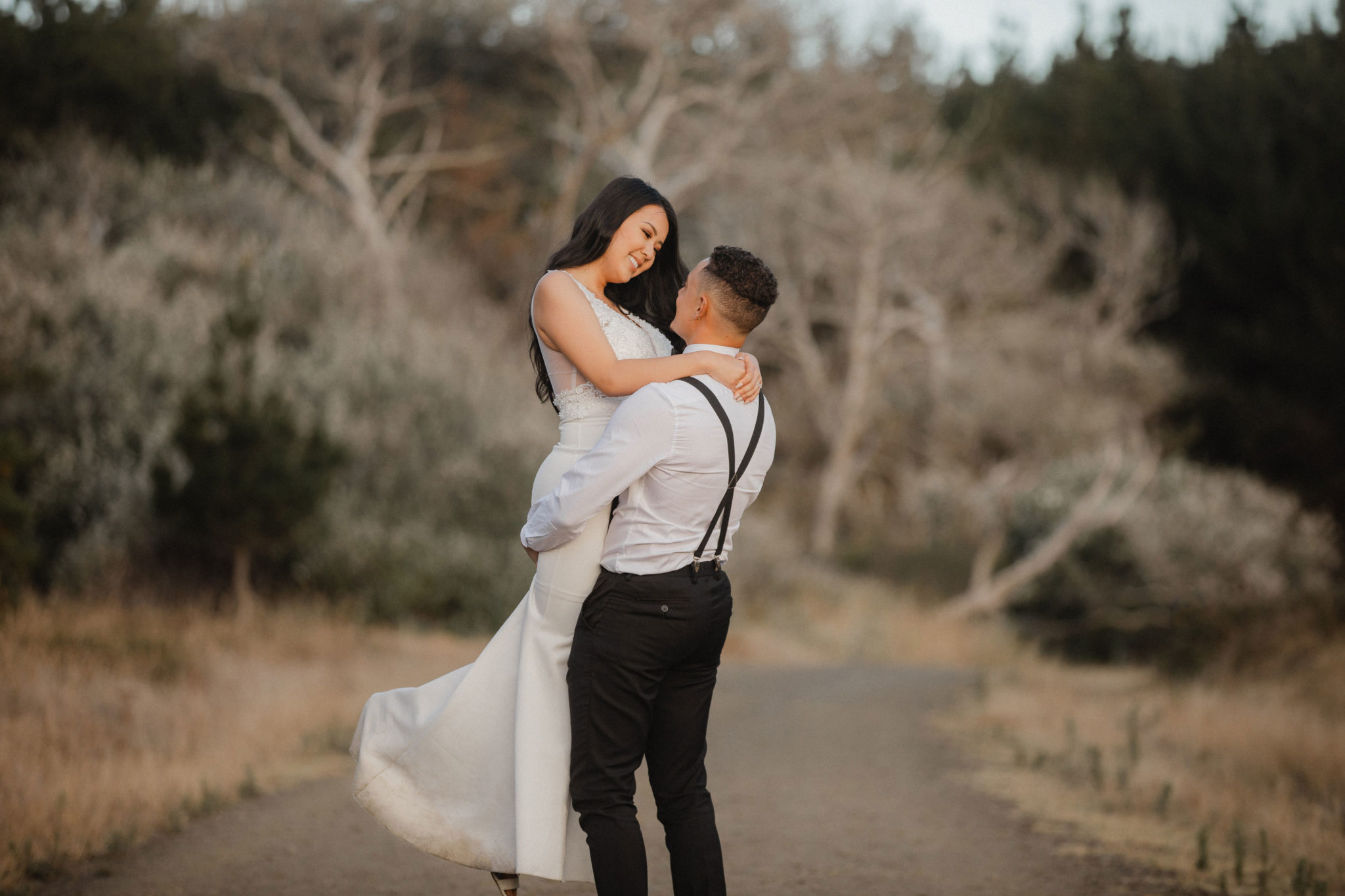 groom lifting bride smiling