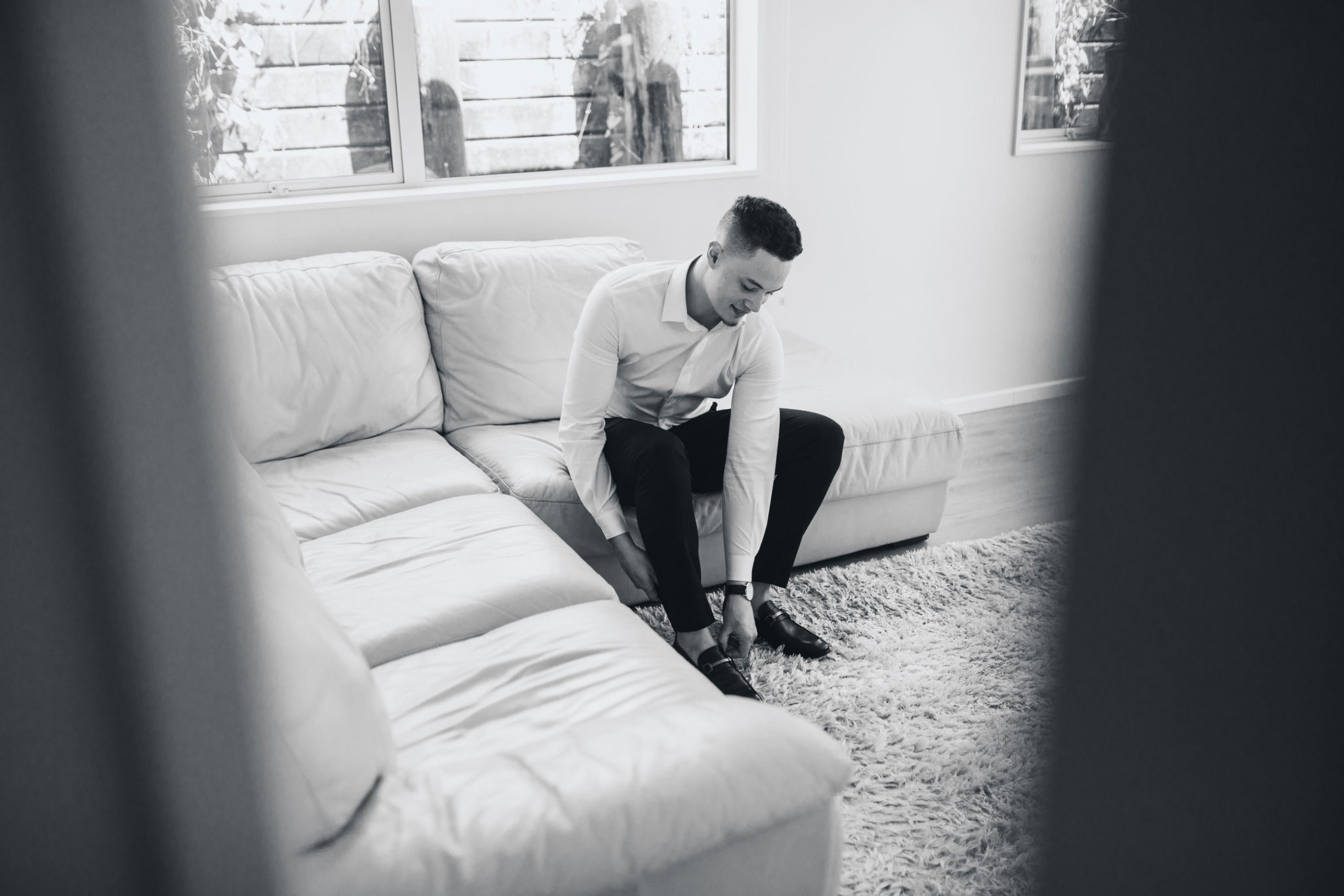 auckland groom putting on shoes