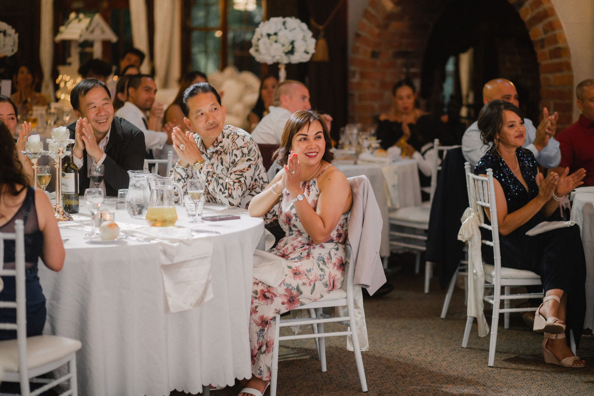 wedding guests cheering at the reception