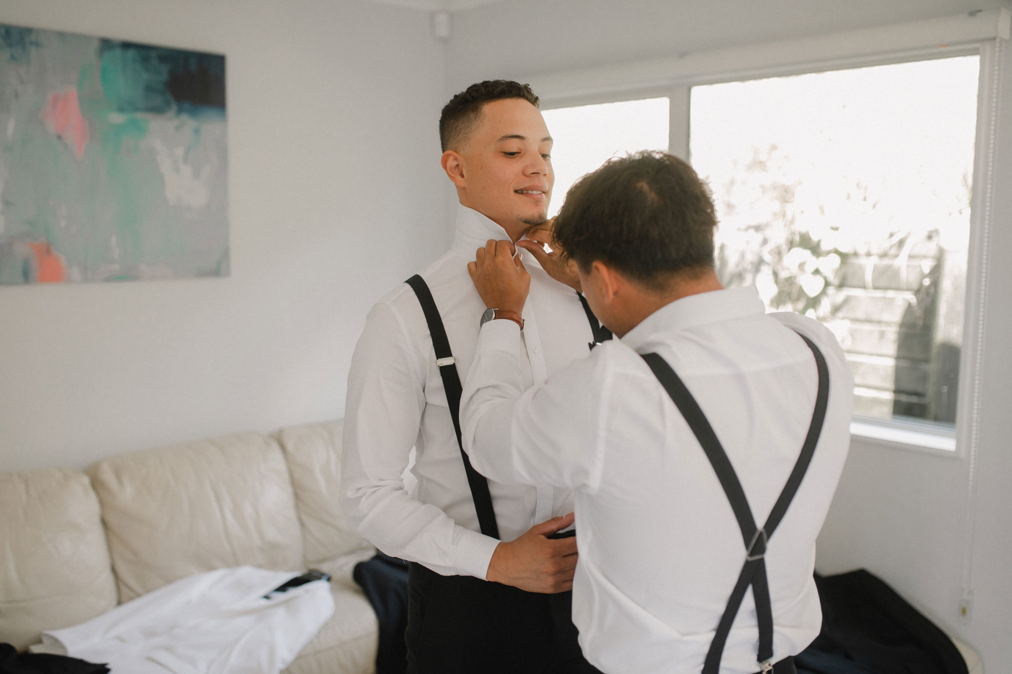 groom putting on bowtie