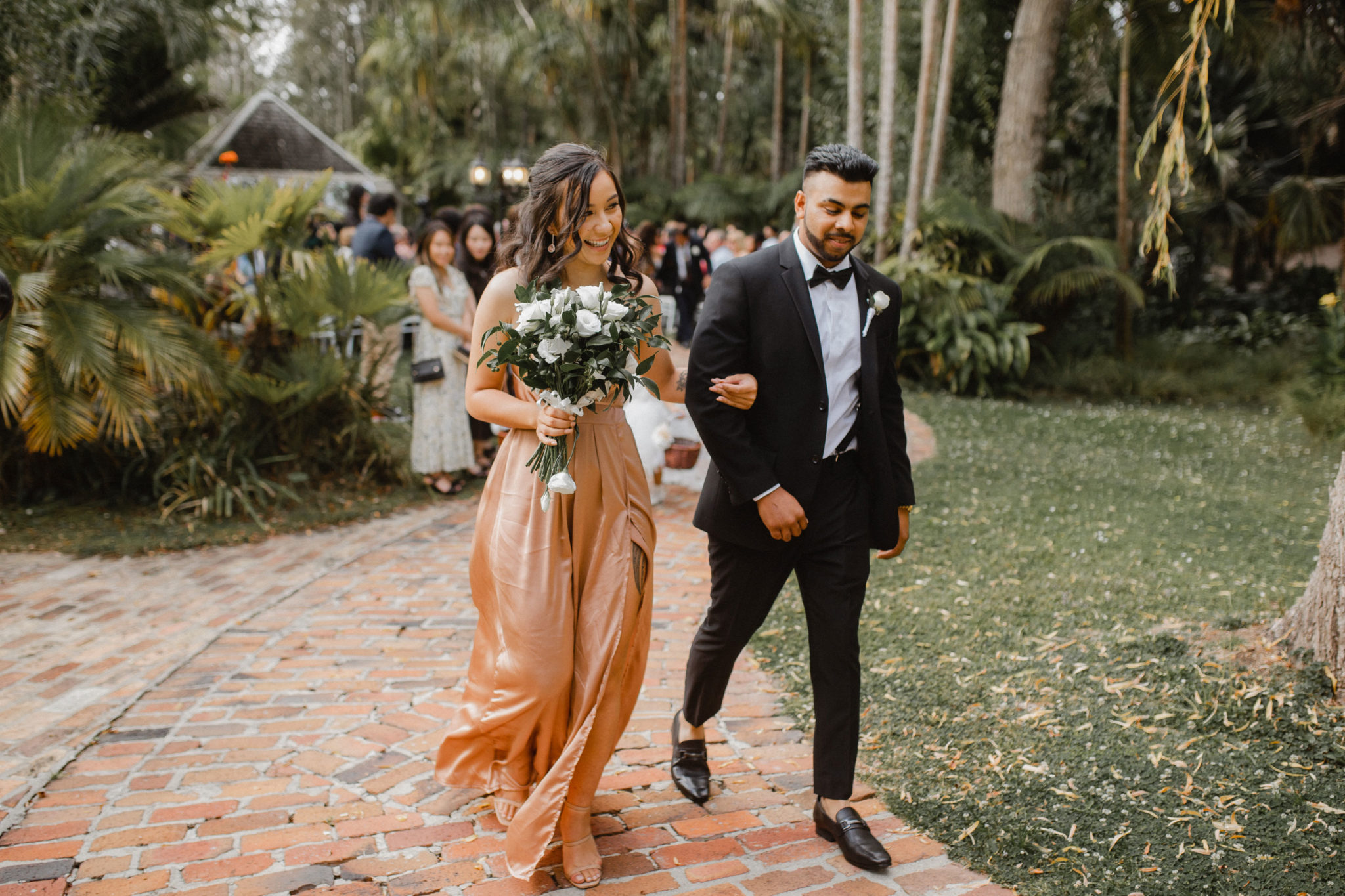 bridesmaid and groomsman walking together