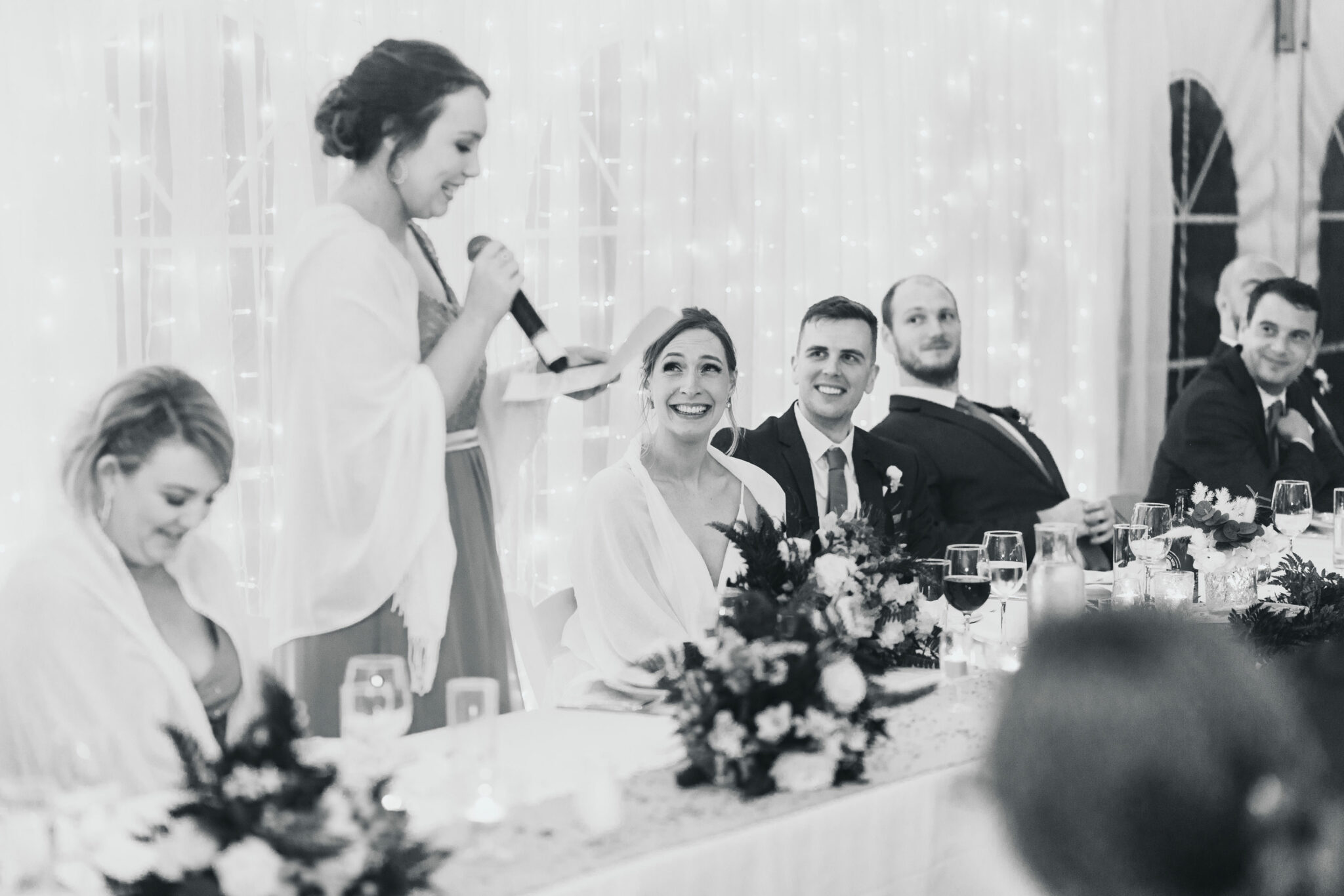 bride laughing at bridesmaid speech