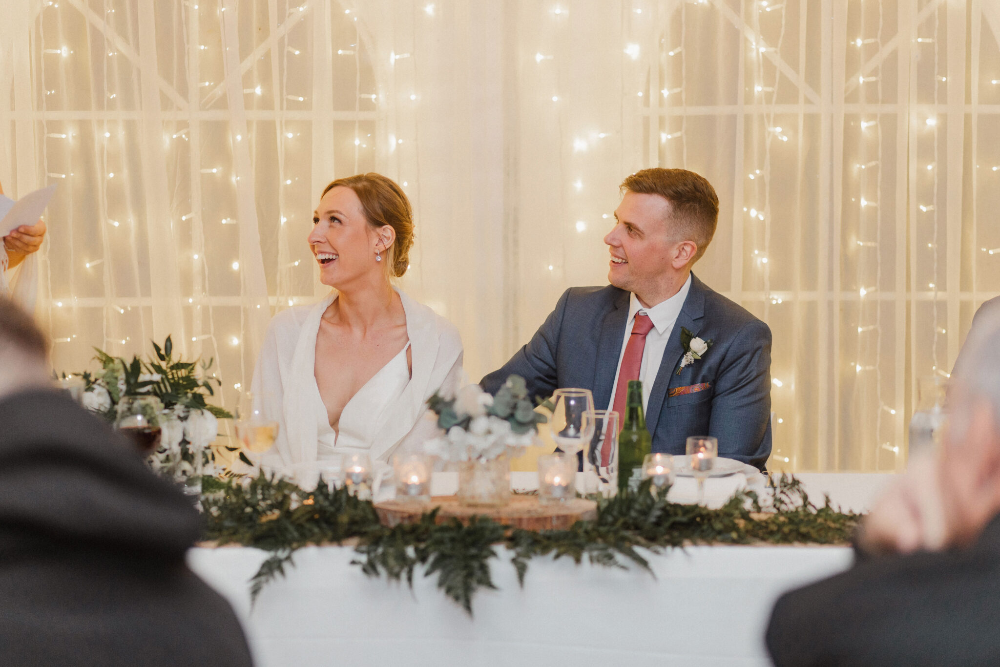 bride and groom react to bridesmaid speech