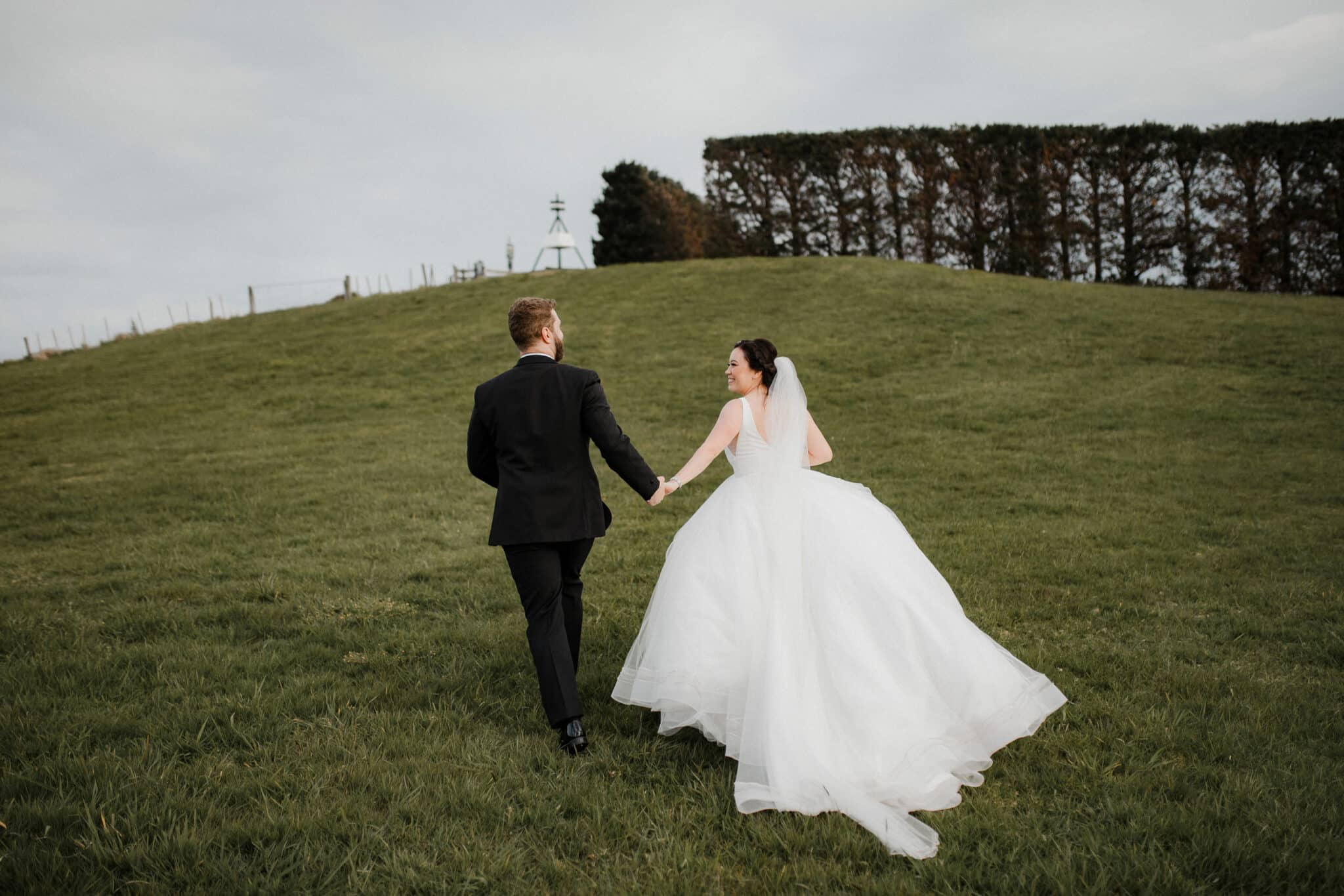 bride and groom on the hill