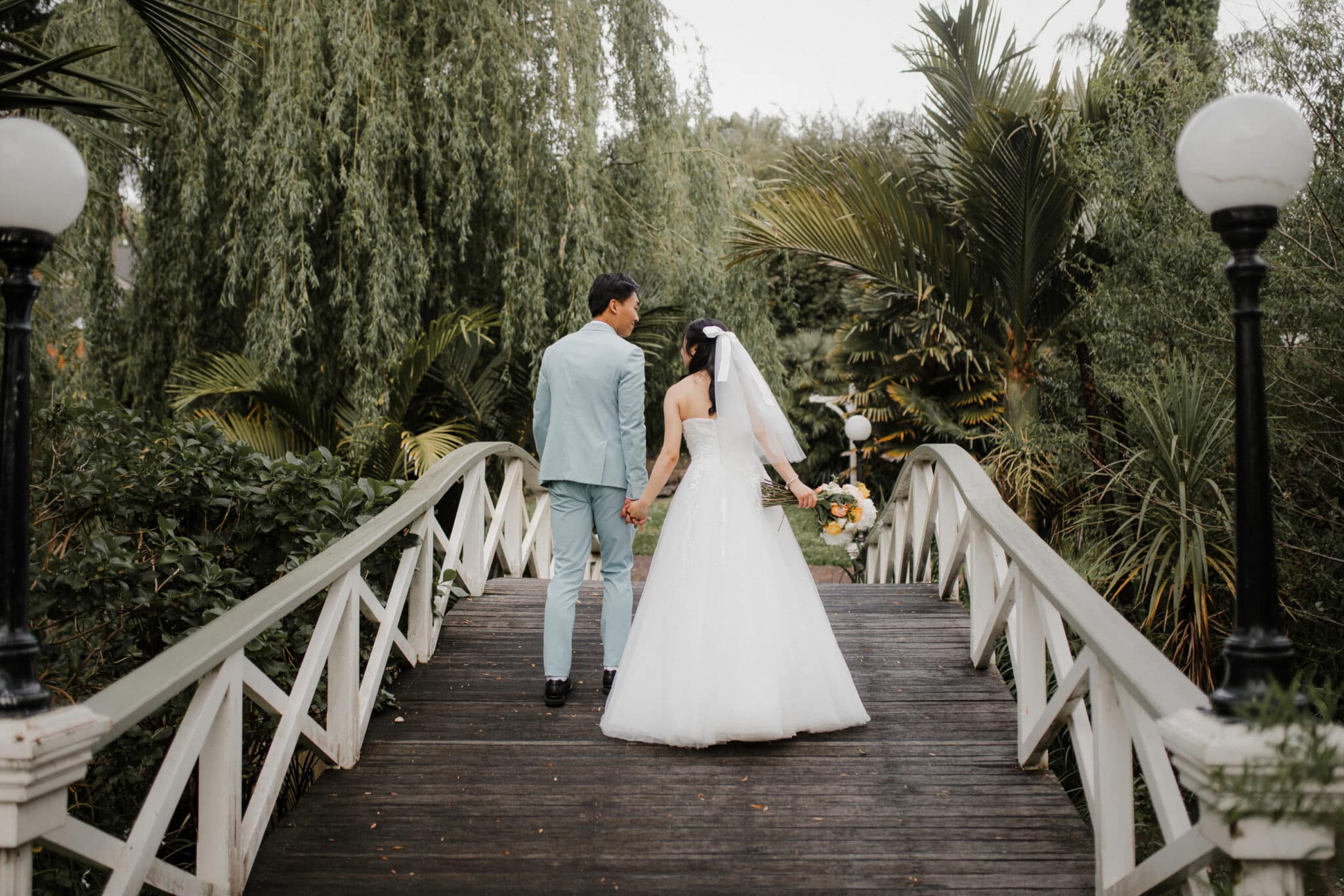 bride and groom on wooden bridge