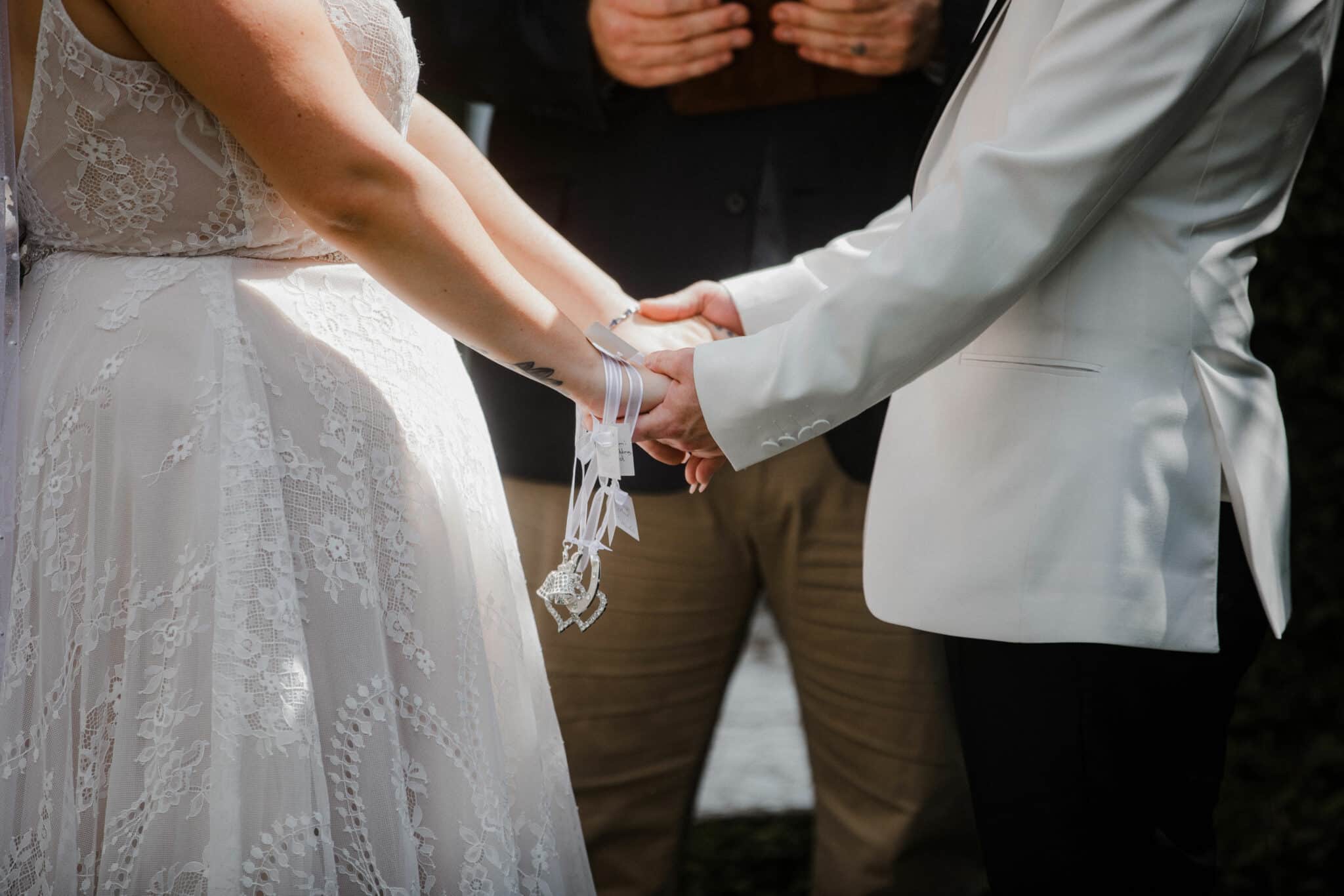 couple holding hands at the ceremony