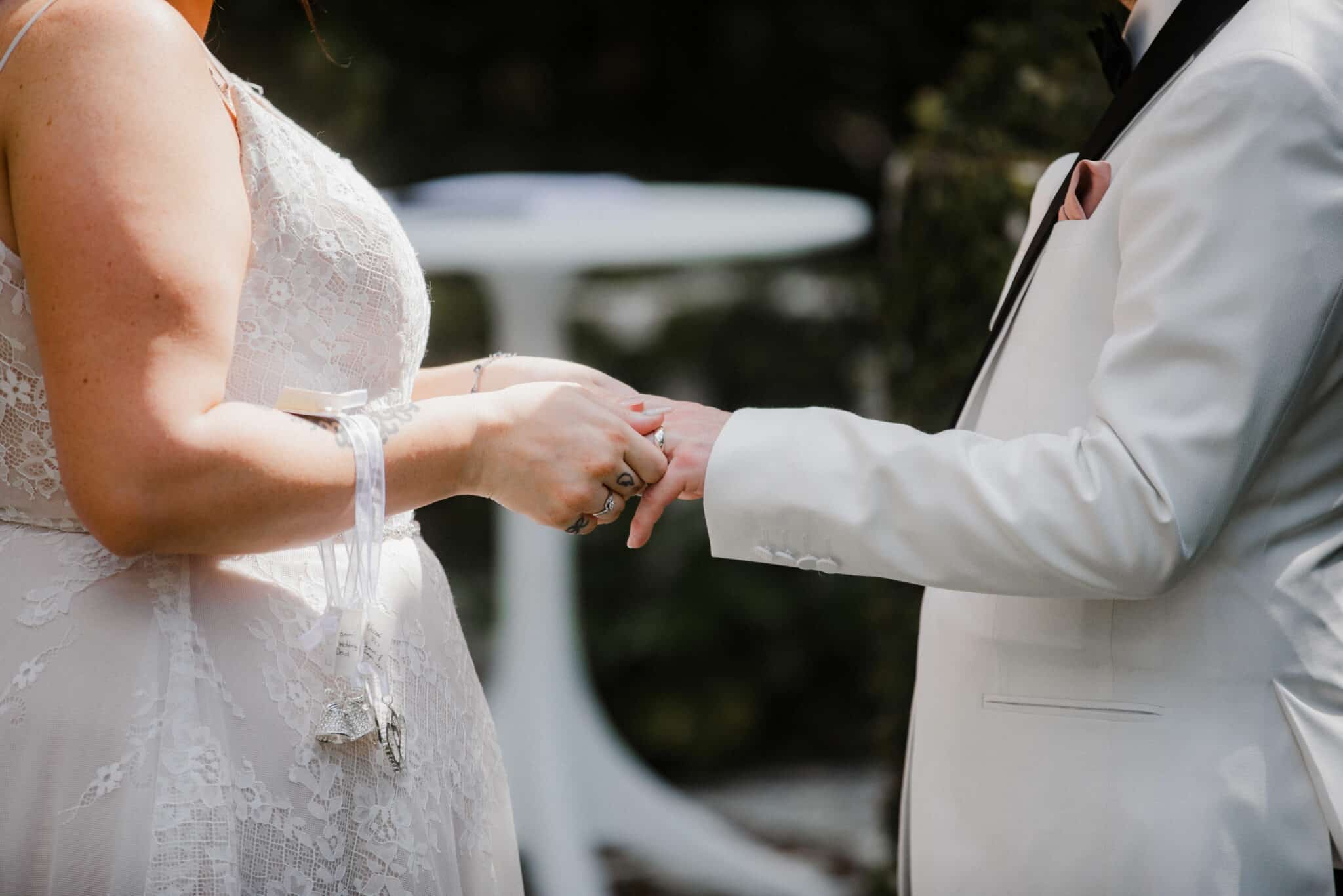 close up photo of couple holding hands at the ceremony