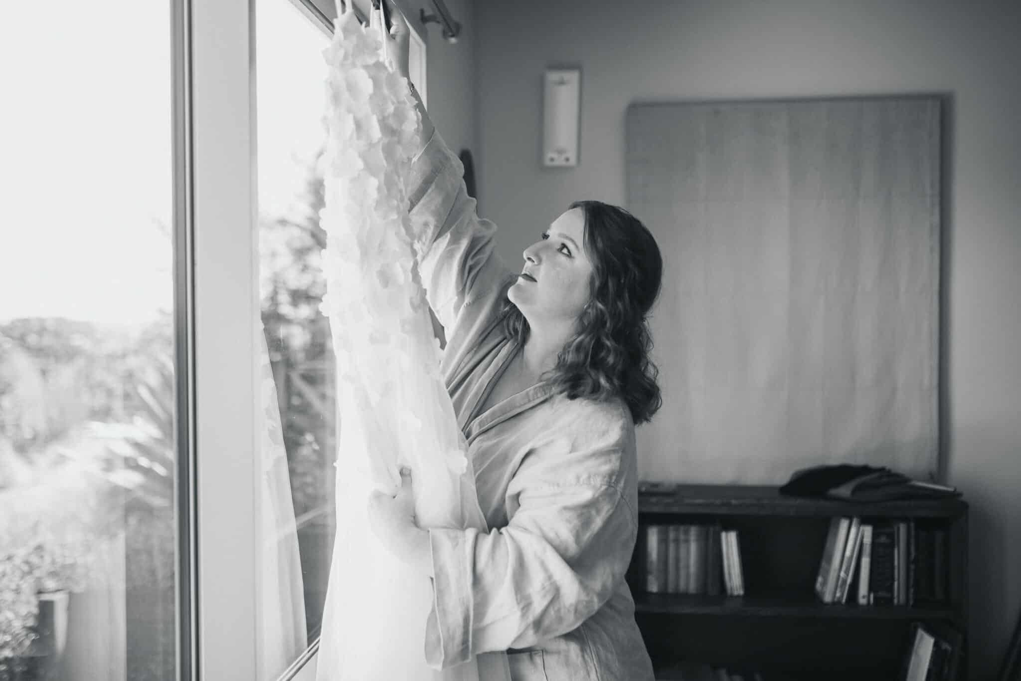 auckland bride looking at her wedding dress