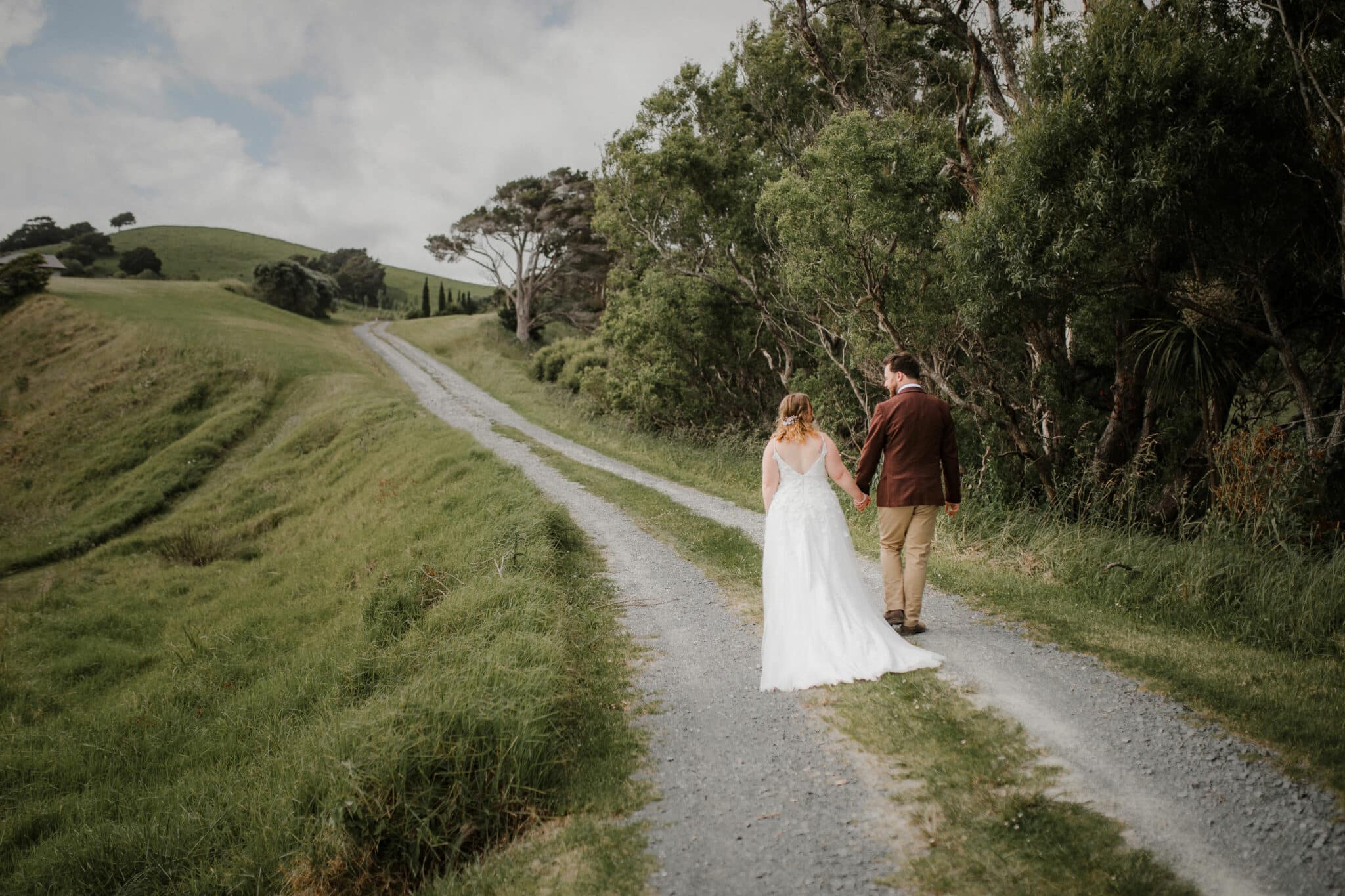 bride and groom walking along the road