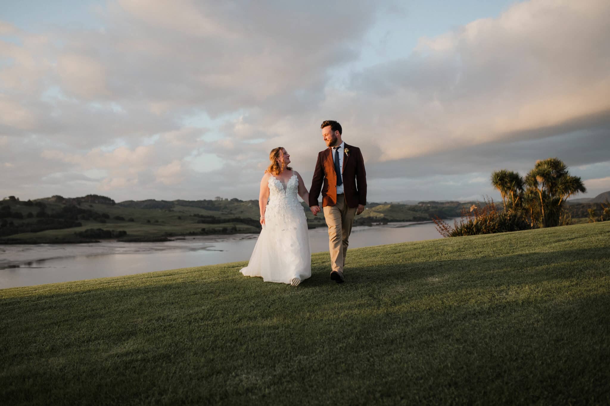 bride and groom walking during sunset